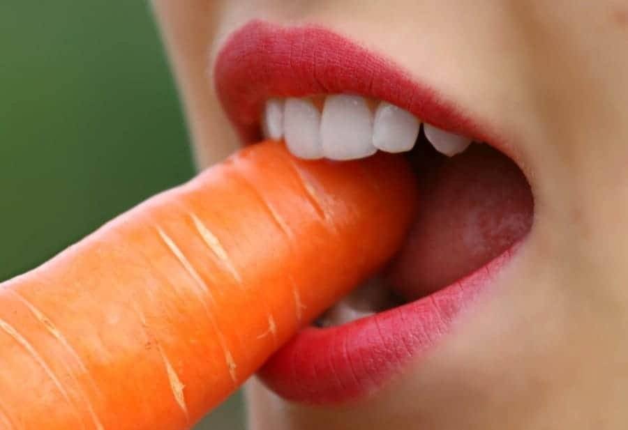 girl biting a carrot