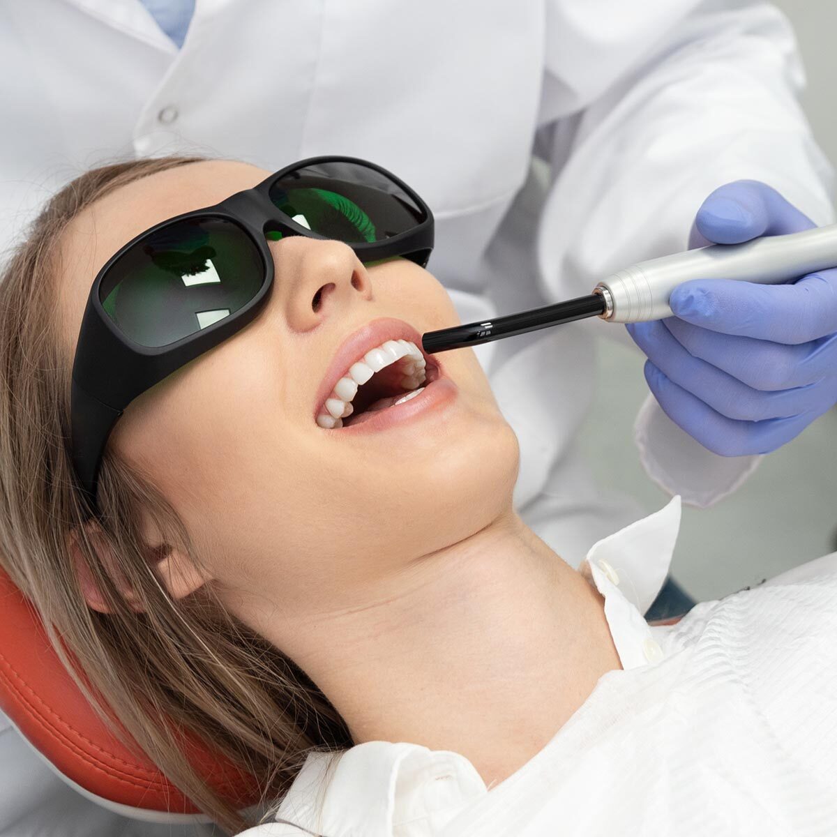 Using a modern method of laser teeth treatment. Dental care, perfect smile